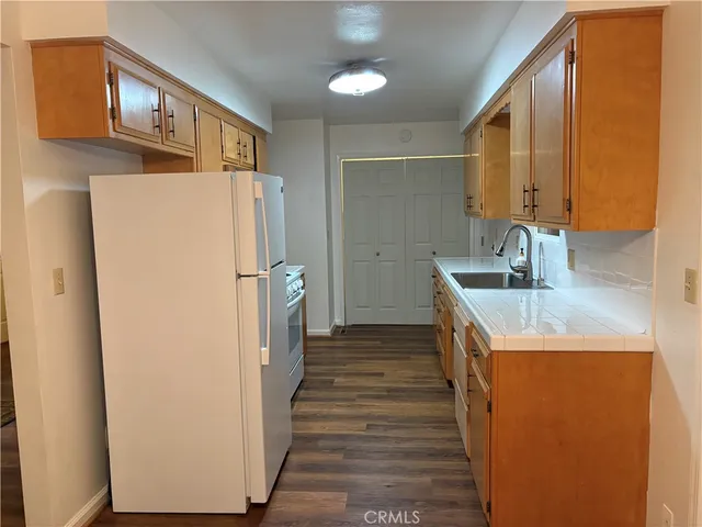 a kitchen with a refrigerator and a sink