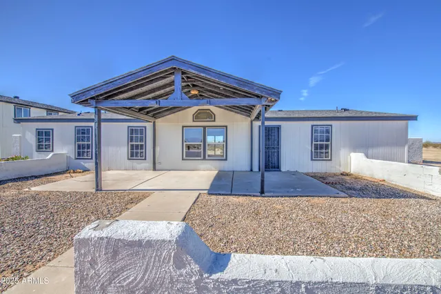 a view of an empty room with window and fire place