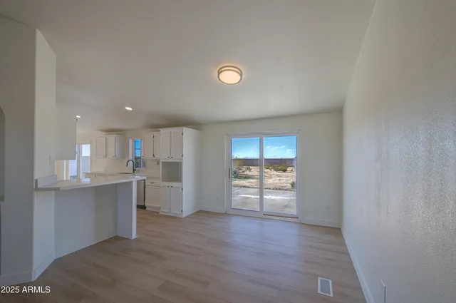 a kitchen with granite countertop white cabinets and appliances