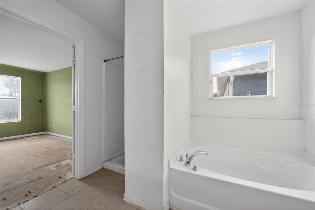 512 Flower Fields Lane Orlando, FL 32824 - Photo 12 of 28 a bathroom with a tub shower and a sink