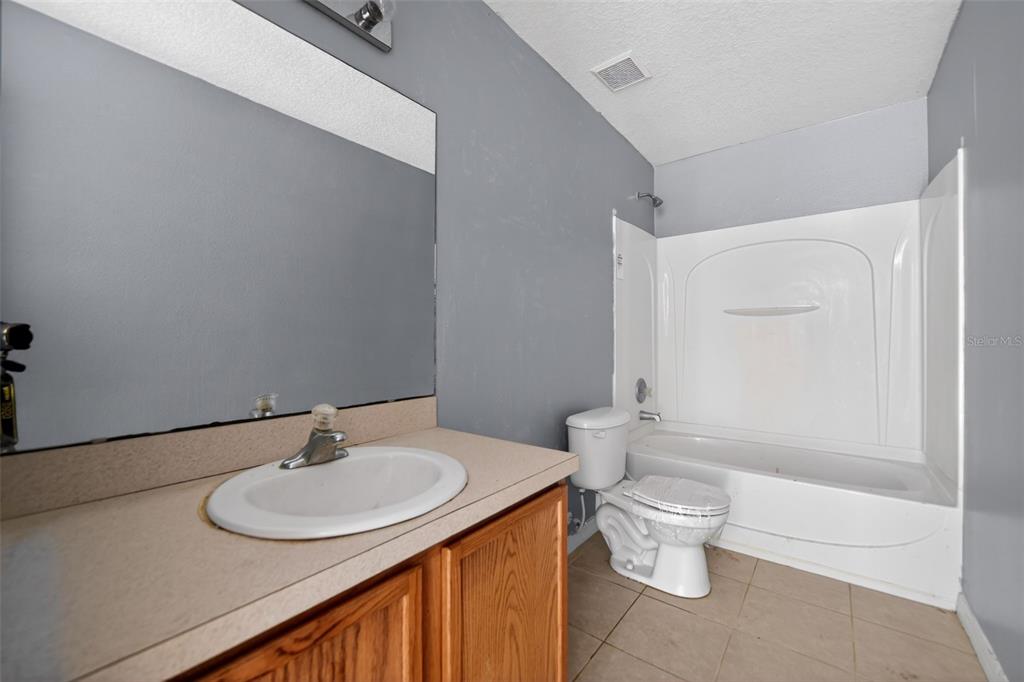 512 Flower Fields Lane Orlando, FL 32824 - Photo 19 of 28 a bathroom with a sink and a mirror
