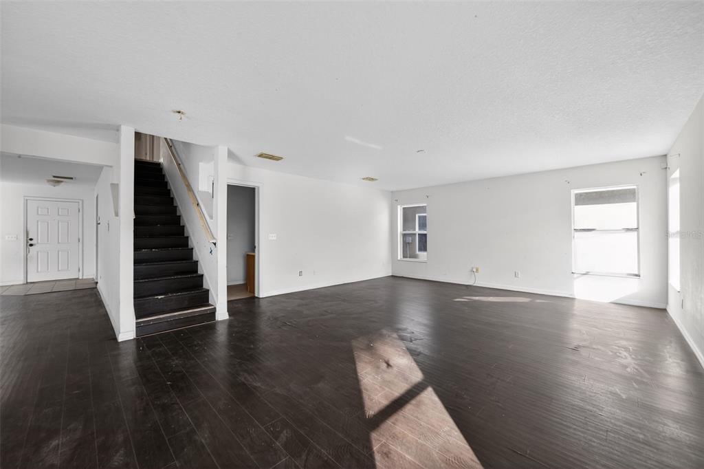 512 Flower Fields Lane Orlando, FL 32824 - Photo 8 of 28 wooden floor in an empty room with a window