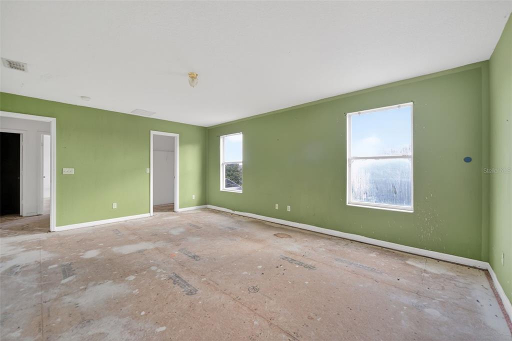 512 Flower Fields Lane Orlando, FL 32824 - Photo 9 of 28 a view of an empty room with window and closet area