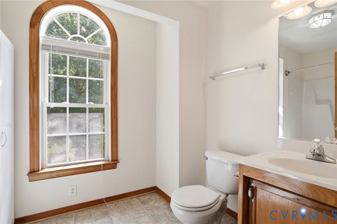 14420 Branding Iron Road Chesterfield, VA 23838 - Photo 31 of 50 Arch-top window with wood trim, white vanity with
