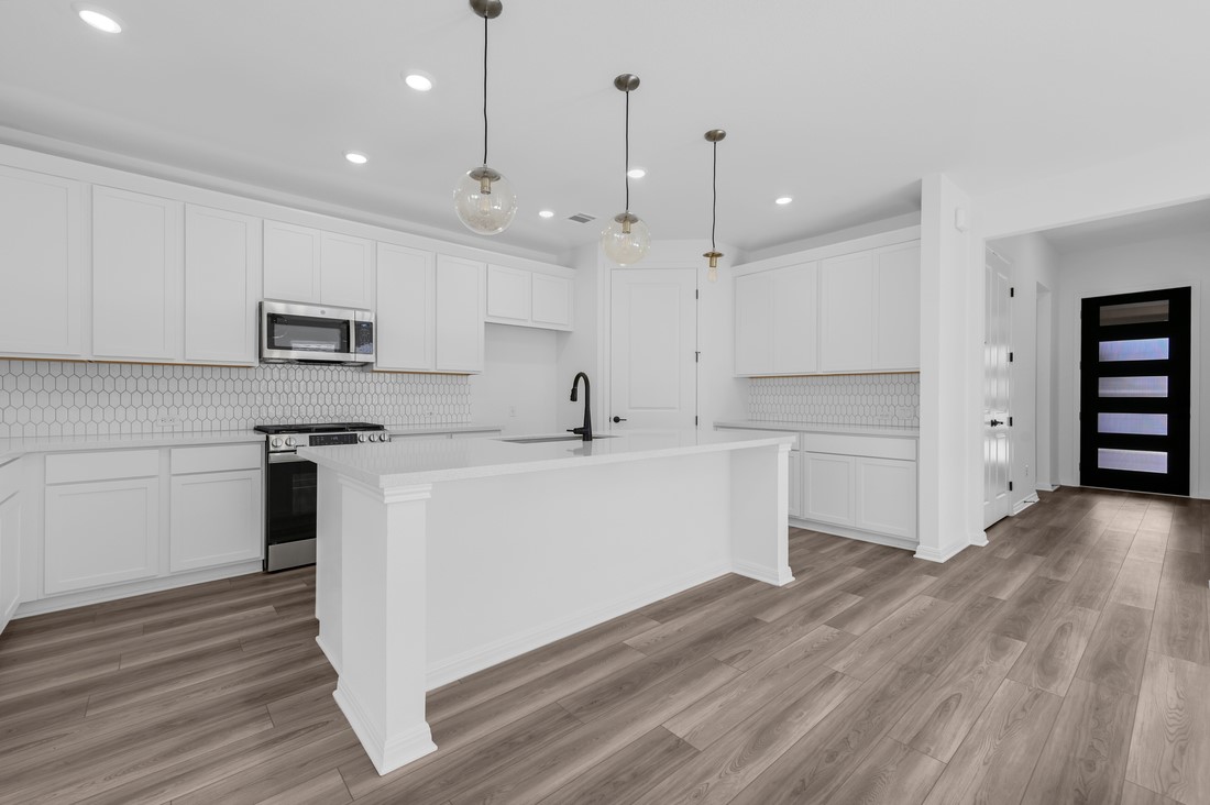 113 Wingstem Way Georgetown, TX 78633 - Photo 2 of 37 a kitchen with a sink stainless steel appliances and cabinets