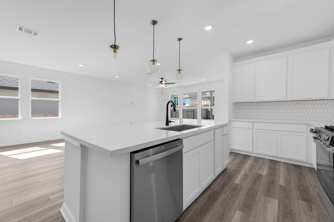 113 Wingstem Way Georgetown, TX 78633 - Photo 3 of 37 a kitchen with a sink window and cabinets