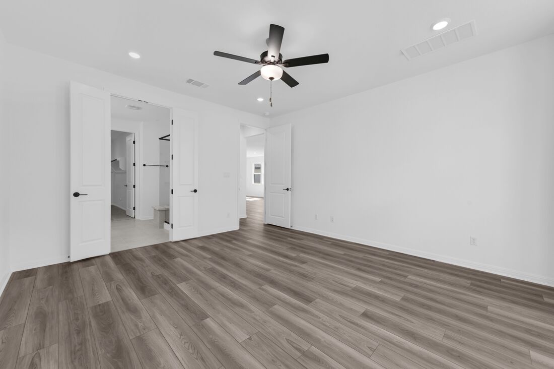 113 Wingstem Way Georgetown, TX 78633 - Photo 8 of 37 a view of an empty room with wooden floor and a ceiling fan