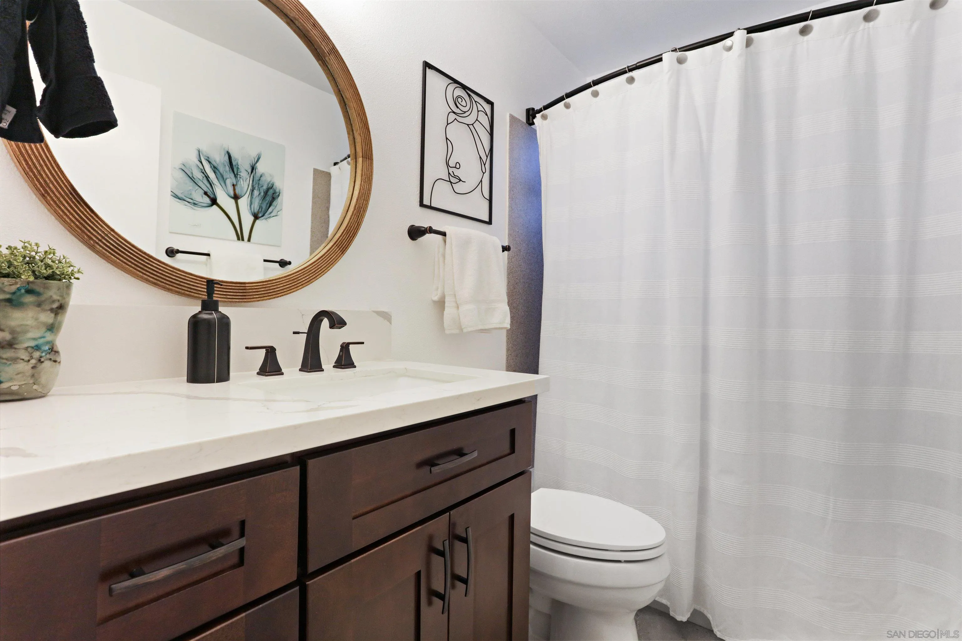 14607 Bowdoin Road Poway, CA 92064 - Photo 15 of 30 a bathroom with a sink a toilet and a mirror