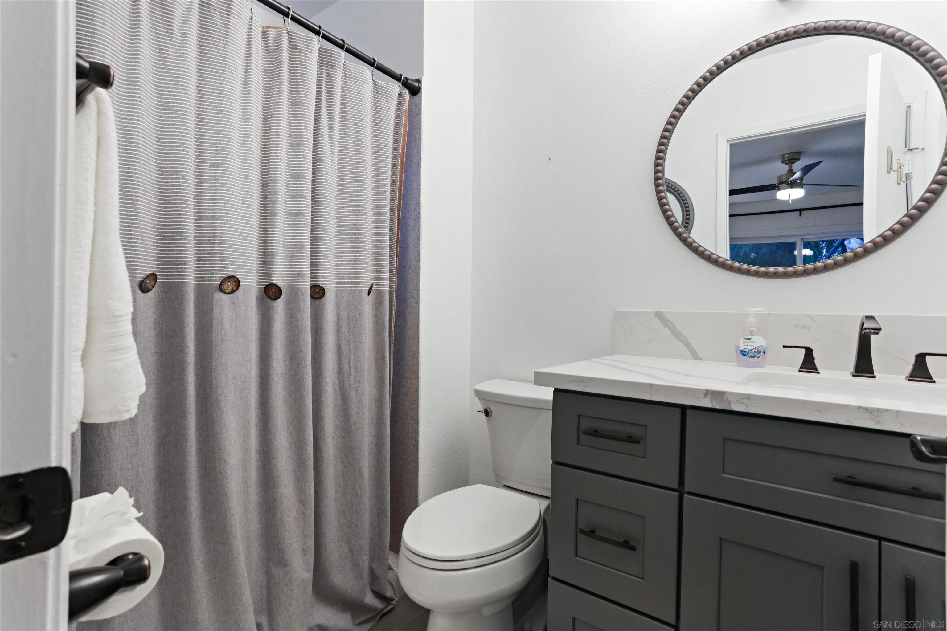 14607 Bowdoin Road Poway, CA 92064 - Photo 18 of 30 a bathroom with a toilet a sink and a mirror