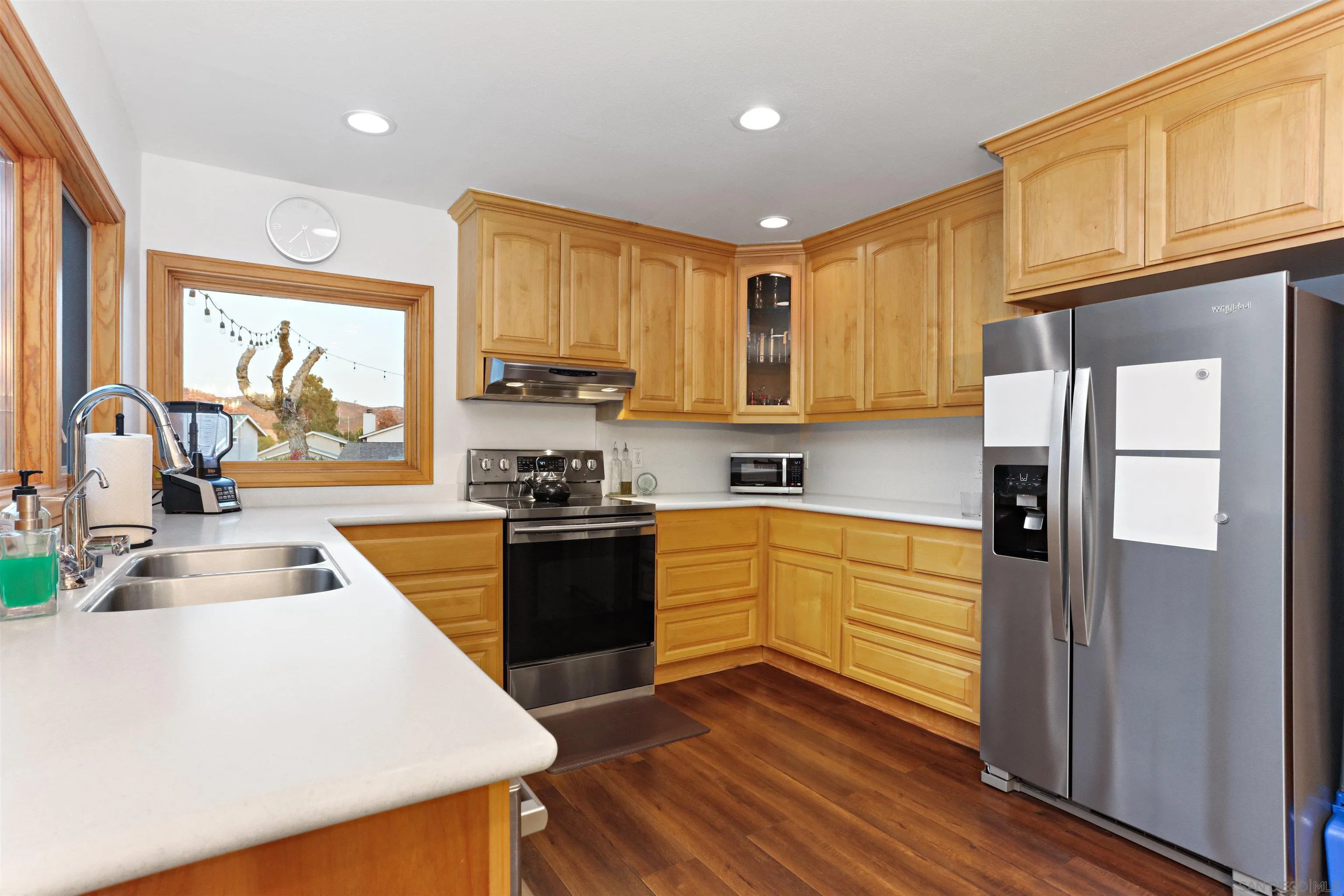 14607 Bowdoin Road Poway, CA 92064 - Photo 8 of 30 a kitchen with stainless steel appliances granite countertop a refrigerator a oven a sink dishwasher and white cabinets with wooden floor
