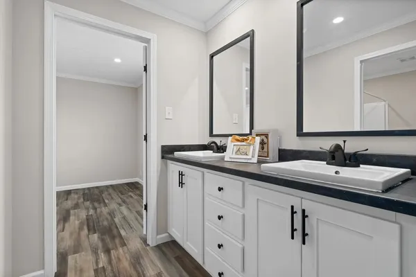a bathroom with a double vanity sink and mirror