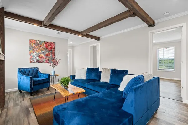 a living room with furniture and wooden floor