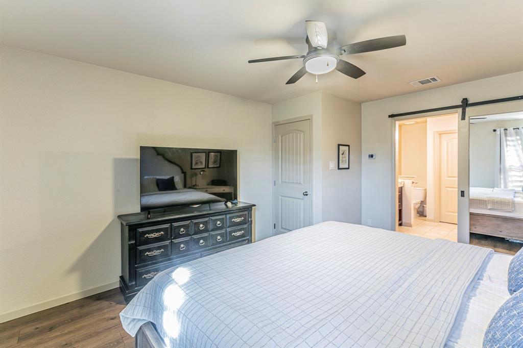 2210 Torch Lake Drive Forney, TX 75126 - Photo 11 of 29 a bedroom with a bed and a television