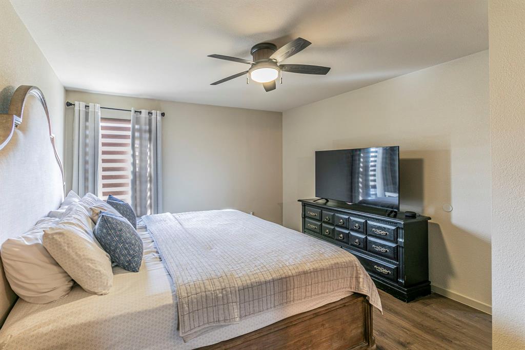 2210 Torch Lake Drive Forney, TX 75126 - Photo 12 of 29 a bedroom with a bed and a flat screen tv