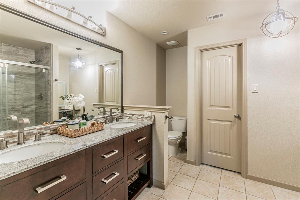 2210 Torch Lake Drive Forney, TX 75126 - Photo 13 of 29 a spacious bathroom with a double vanity sink and a mirror