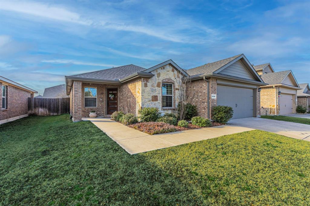 2210 Torch Lake Drive Forney, TX 75126 - Photo 2 of 29 a front view of a house with garden