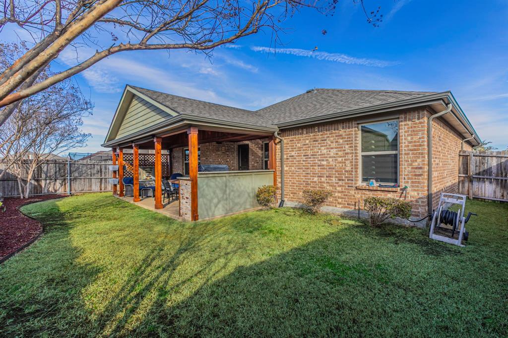 2210 Torch Lake Drive Forney, TX 75126 - Photo 25 of 29 a view of a backyard with plants and large tree