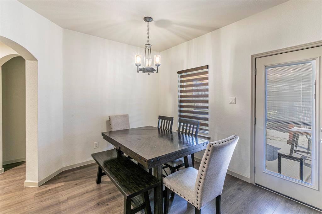 2210 Torch Lake Drive Forney, TX 75126 - Photo 9 of 29 a view of a dining room with furniture wooden floor and chandelier