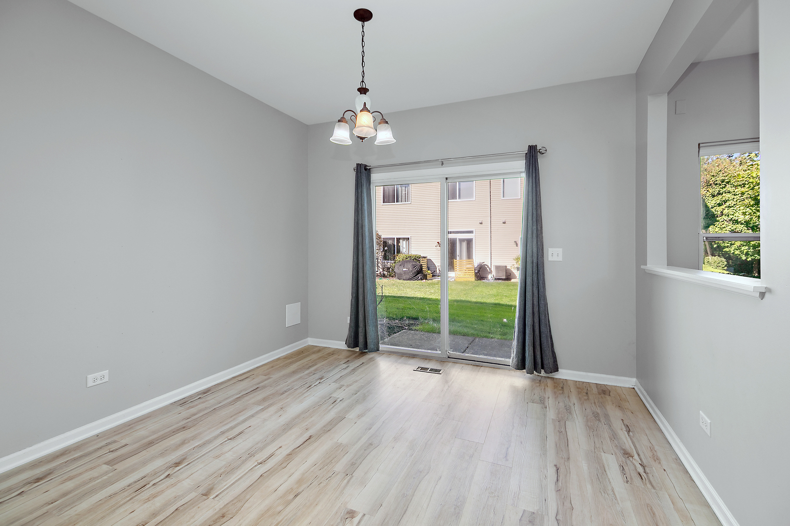 17694 Gilbert Drive Lockport, IL 60441 - Photo 12 of 29 a view of an empty room with a window and wooden floor