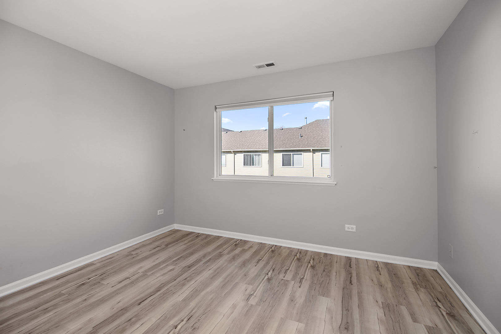 17694 Gilbert Drive Lockport, IL 60441 - Photo 26 of 29 an empty room with wooden floor and windows