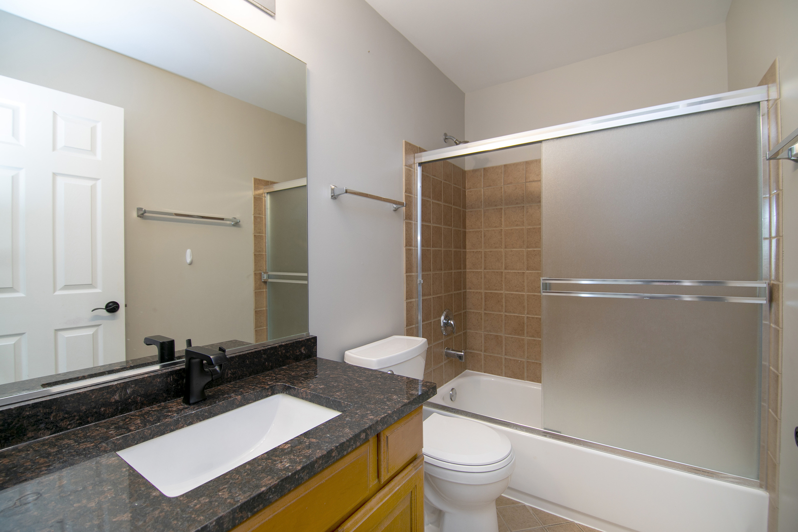 17694 Gilbert Drive Lockport, IL 60441 - Photo 28 of 29 a bathroom with a granite countertop sink toilet and shower