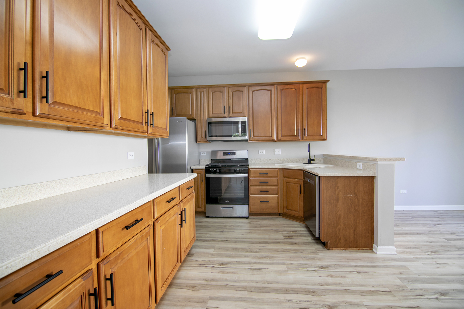 17694 Gilbert Drive Lockport, IL 60441 - Photo 7 of 29 a kitchen with stainless steel appliances granite countertop a stove a sink and a refrigerator