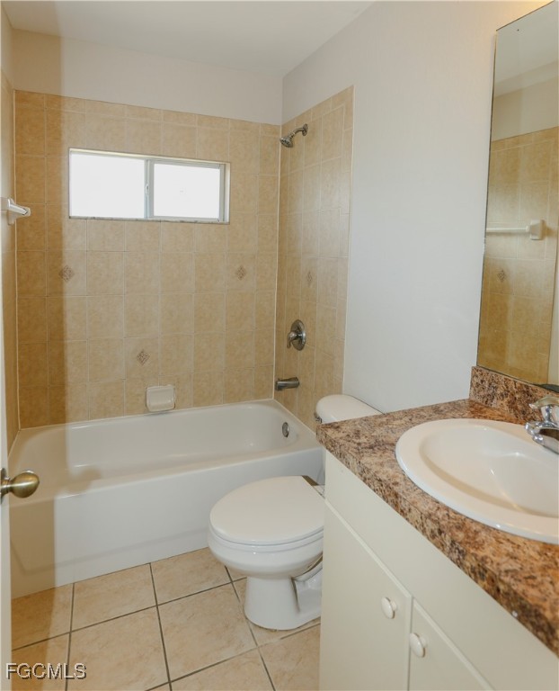 4612 25th Street Southwest Lehigh Acres, FL 33973 - Photo 15 of 15 a bathroom with a granite countertop sink a toilet and bathtub