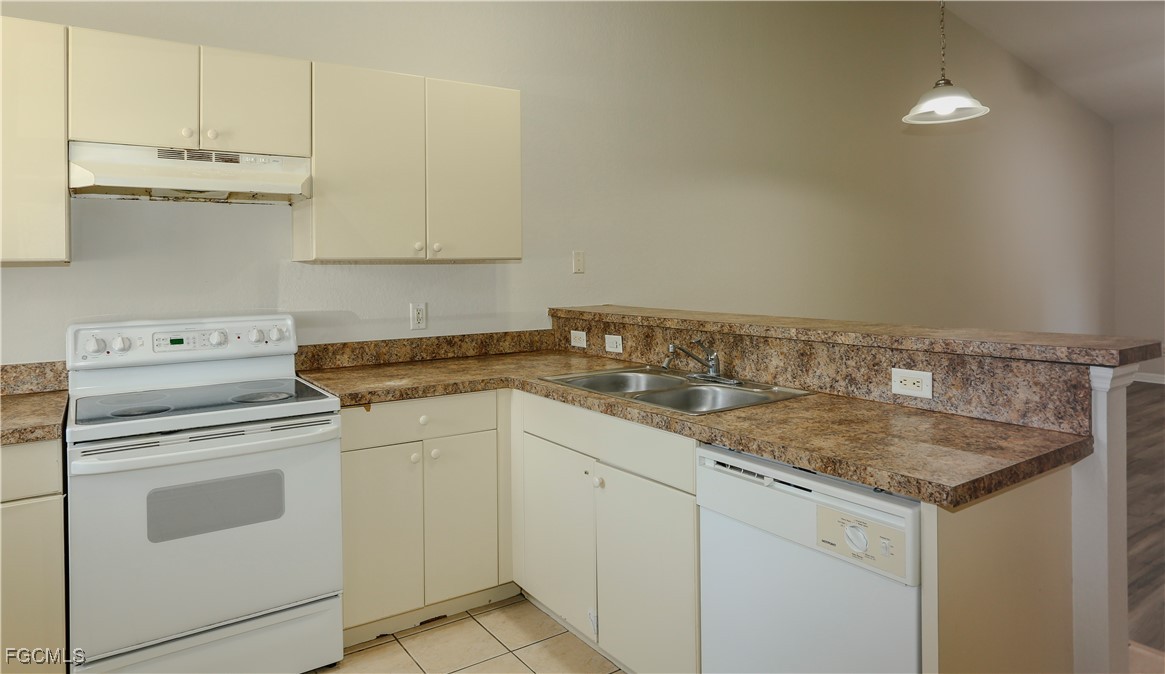 4612 25th Street Southwest Lehigh Acres, FL 33973 - Photo 7 of 15 a kitchen with granite countertop white cabinets and white appliances