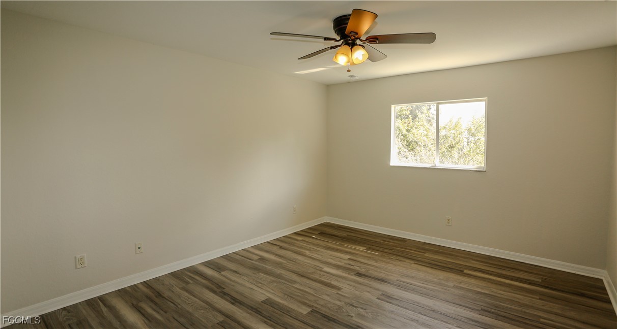 4612 25th Street Southwest Lehigh Acres, FL 33973 - Photo 8 of 15 an empty room with a window and a fan