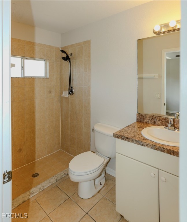 4612 25th Street Southwest Lehigh Acres, FL 33973 - Photo 10 of 15 a bathroom with a granite countertop sink toilet and shower