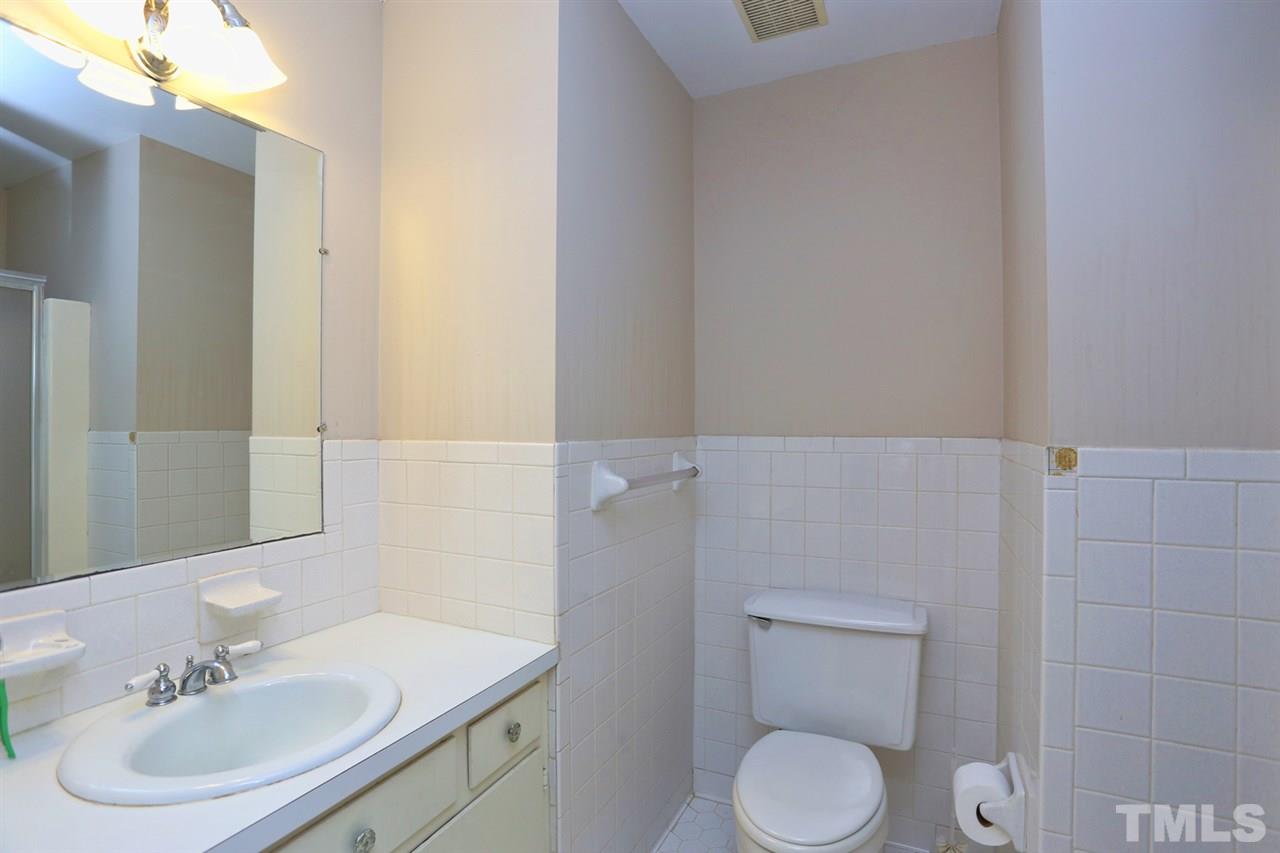 2860 Wycliff Road Raleigh, NC 27607 - Photo 16 of 25 a bathroom with a toilet sink and mirror