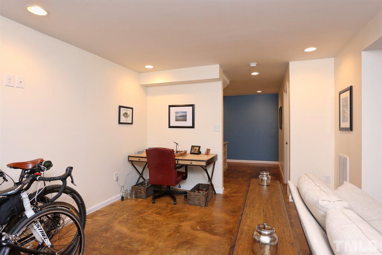 2860 Wycliff Road Raleigh, NC 27607 - Photo 18 of 25 a view of a workspace with furniture and a bedroom