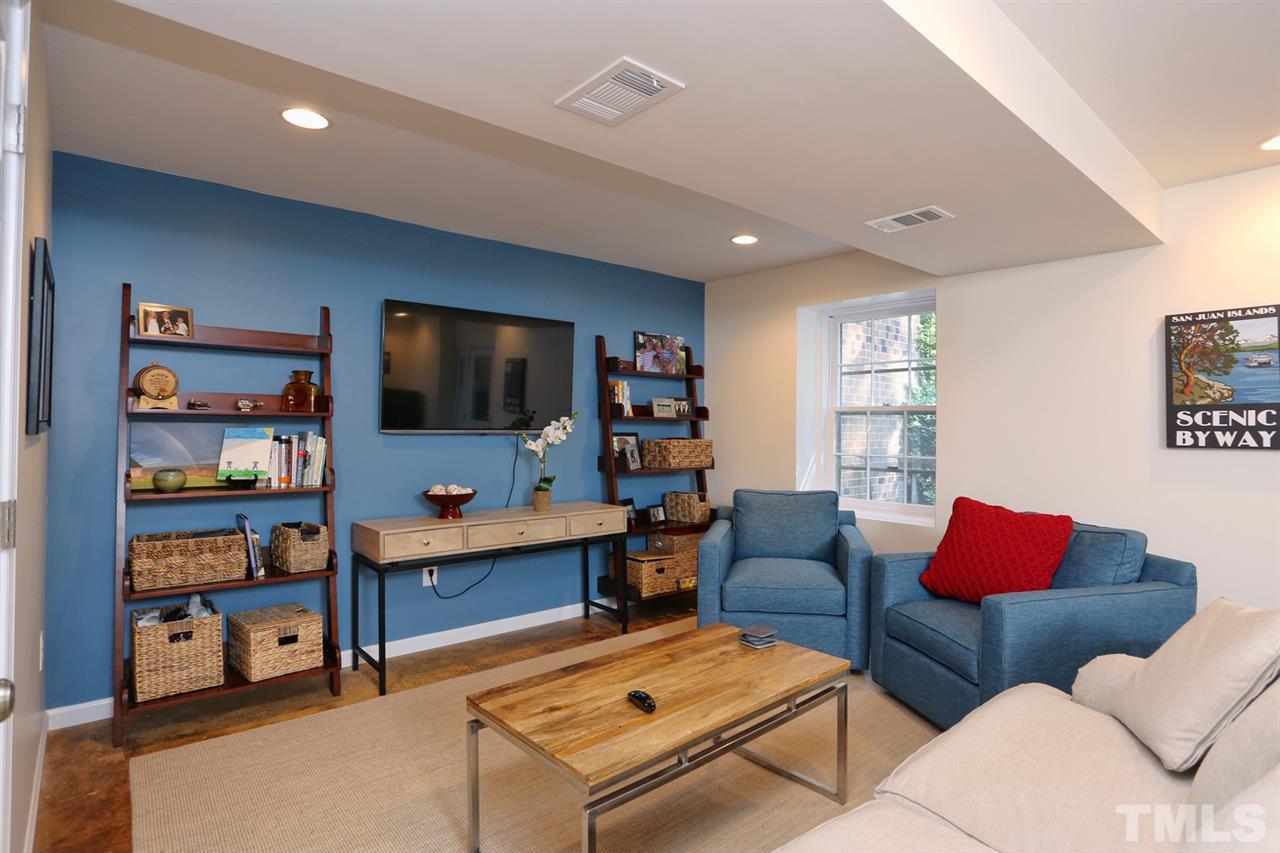 2860 Wycliff Road Raleigh, NC 27607 - Photo 19 of 25 a living room with furniture and a flat screen tv