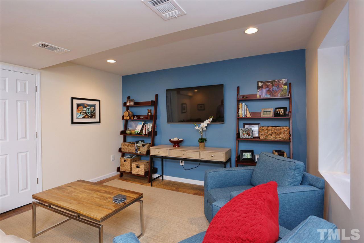 2860 Wycliff Road Raleigh, NC 27607 - Photo 20 of 25 a living room with furniture and a flat screen tv