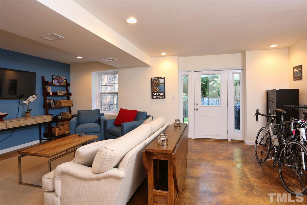 2860 Wycliff Road Raleigh, NC 27607 - Photo 21 of 25 a living room with furniture and a flat screen tv