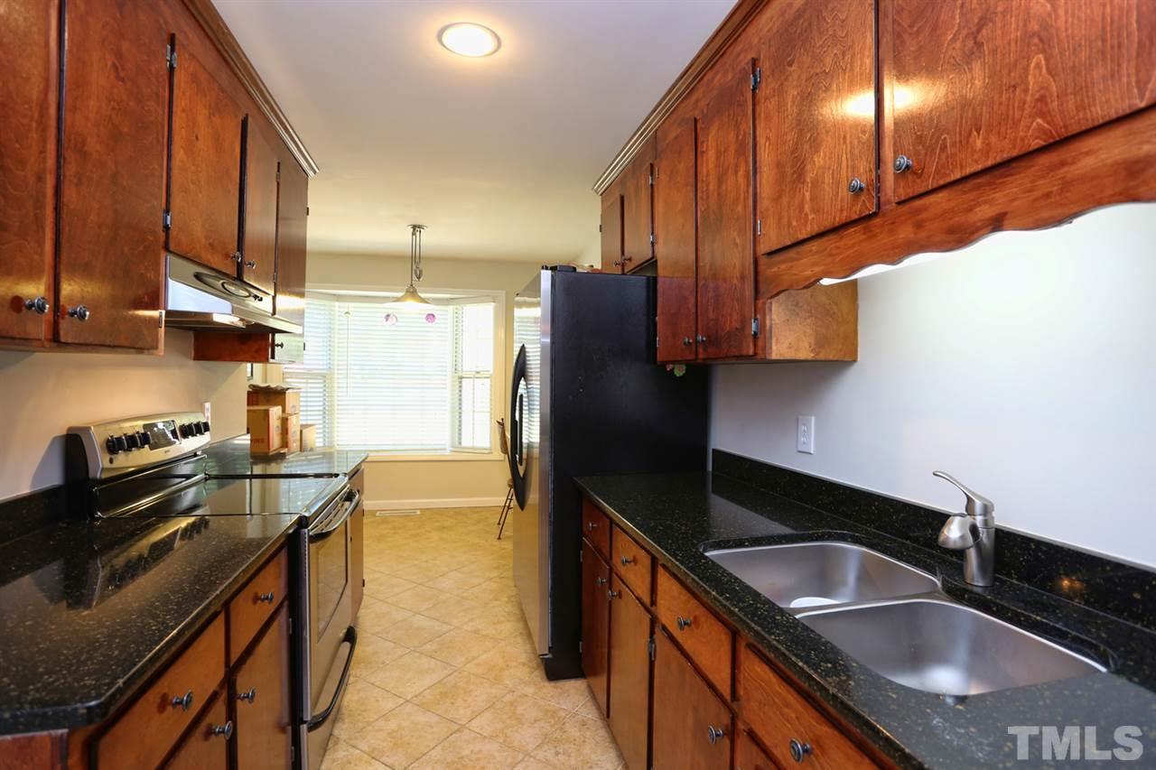 2860 Wycliff Road Raleigh, NC 27607 - Photo 9 of 25 a kitchen with stainless steel appliances granite countertop a sink stove and refrigerator