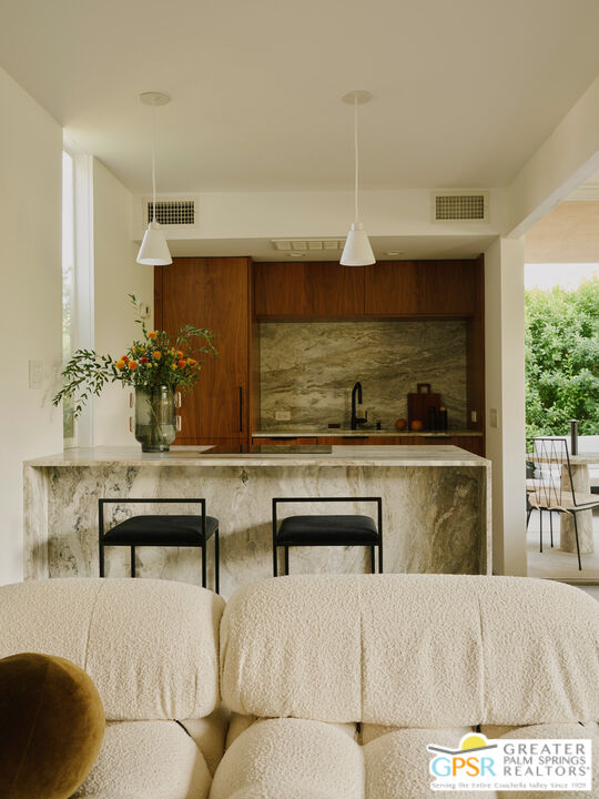 360 Cabrillo Road, Unit 101 Palm Springs, CA 92262 - Photo 12 of 39 a living room with furniture and a table