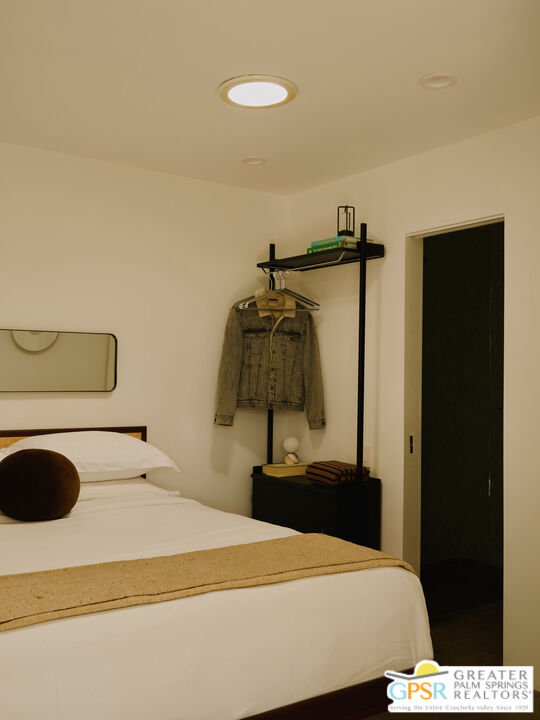 360 Cabrillo Road, Unit 101 Palm Springs, CA 92262 - Photo 20 of 39 a bedroom with a bed and cabinets