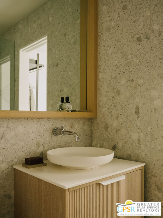 360 Cabrillo Road, Unit 101 Palm Springs, CA 92262 - Photo 21 of 39 a bathroom with a sink and a mirror