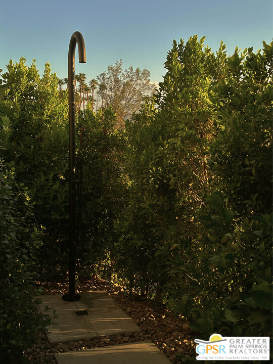 360 Cabrillo Road, Unit 101 Palm Springs, CA 92262 - Photo 22 of 39 a front view of a house with a yard