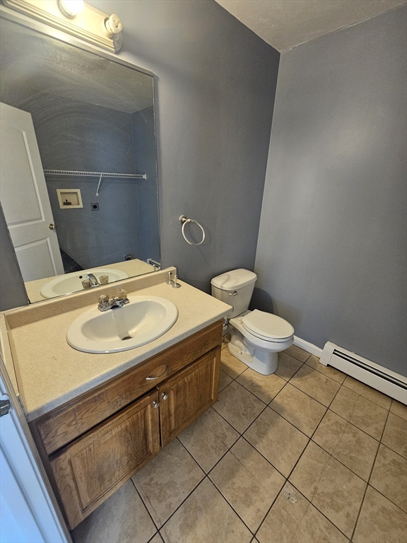 40 Merrick Street, Unit A Worcester, MA 01609 - Photo 8 of 32 a bathroom with a sink toilet and mirror