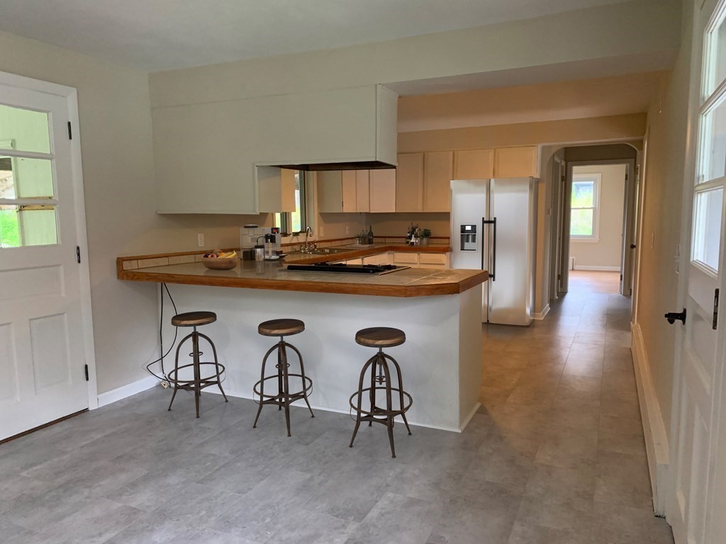 3 Sasur Street Three Rivers, MA 01080 - Photo 3 of 35 a kitchen with stainless steel appliances granite countertop a table and chairs in it