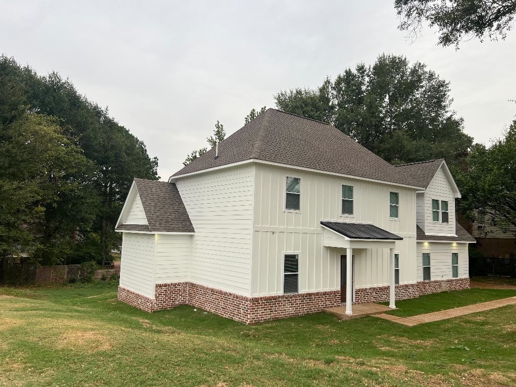56 South Sanga Road Cordova, TN 38018 - Photo 2 of 26 View of front of house with a shingled roof, a front yard, and board and batten siding