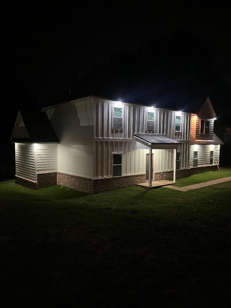 56 South Sanga Road Cordova, TN 38018 - Photo 4 of 26 View of front facade with a lawn and board and batten siding
