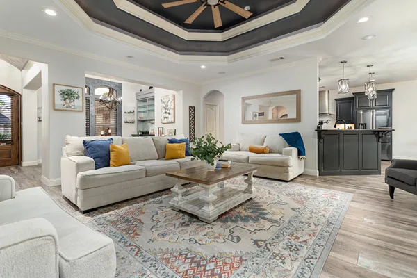 a living room with furniture and a chandelier