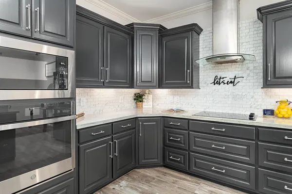 a kitchen with granite countertop wooden cabinets and a sink