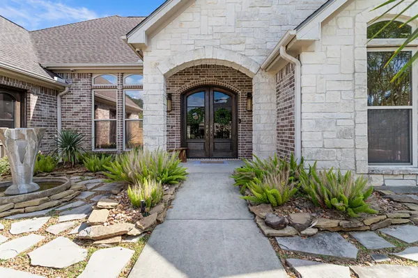 a front view of a house with a garden