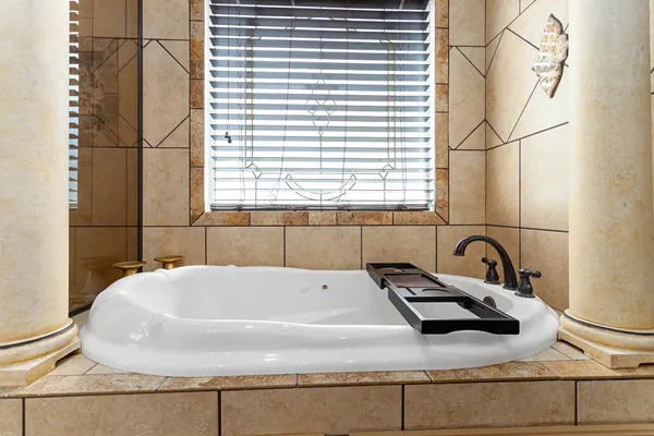 a bathroom with a tub and a sink