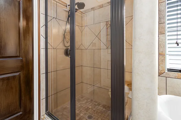 a bathroom with a glass door shower