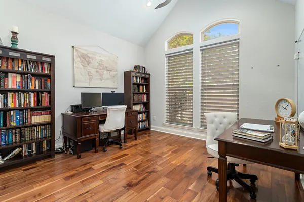 a view of a workspace with furniture and a bookshelf